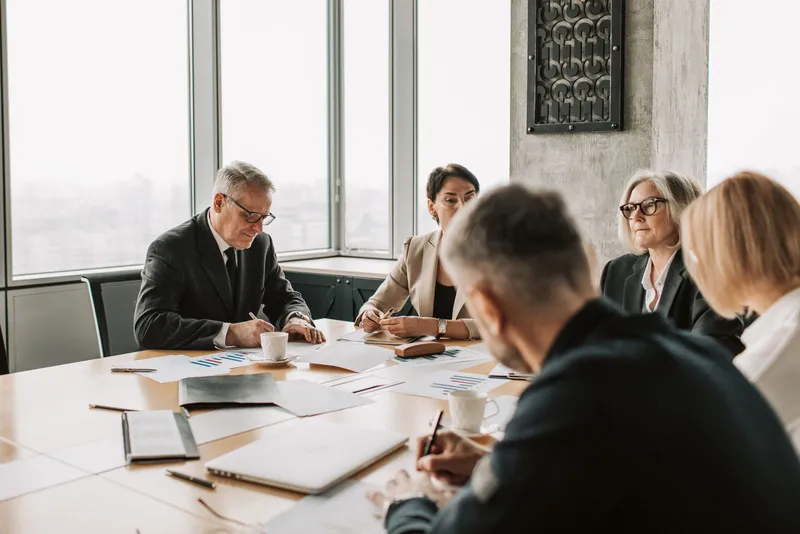 Business professionals in a meeting around a conference table