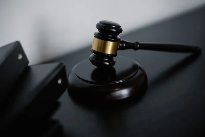 A wooden judge’s gavel on a desk