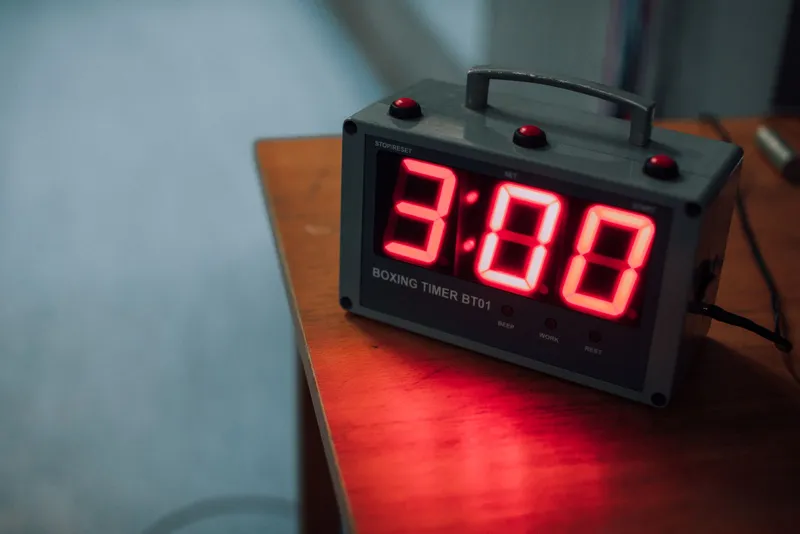 A digital countdown timer on a wooden table