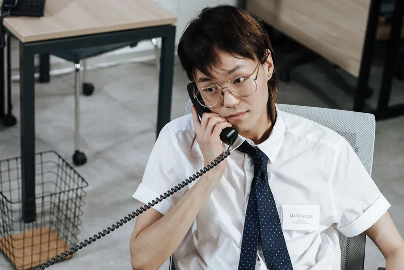 A customer service agent answering a phone call at a desk