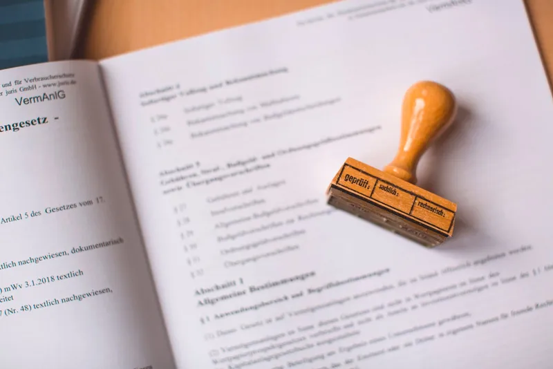 A wooden stamp resting on a printed document