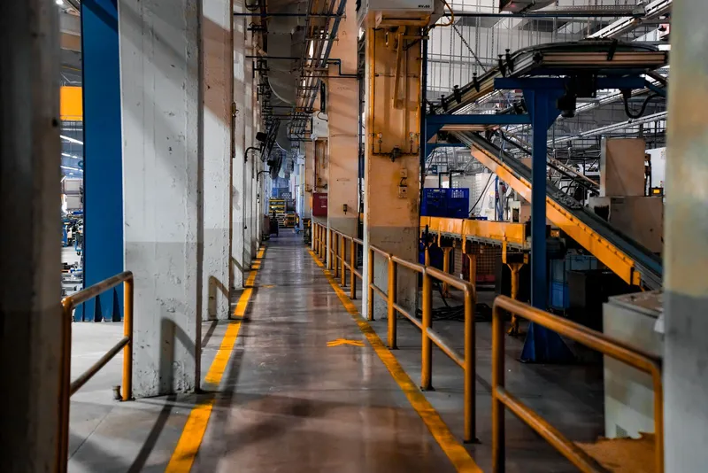 Inside an industrial factory with conveyor belts and walkways